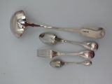 four spoons and a fork on a table