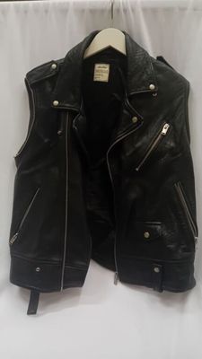 une veste en cuir noir sur un cintre, sur fond blanc