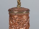 an image of a copper colored cup with a statue on top of it