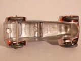 a silver toy car that is sitting on a table