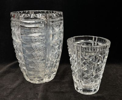 two glass vases sitting next to each other on a table