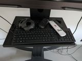 a keyboard, mouse, and mouse pad on a computer desk