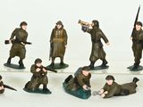 a lot of figurines of soldiers on a white surface