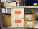 many boxes that are stacked on a shelf in a room
