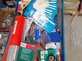 a blue cart filled with assorted items in a room