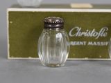 two small glass salt and pepper shakers in front of a box