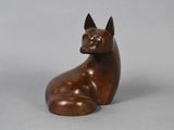 an image of a wooden sculpture of a cat on a gray background