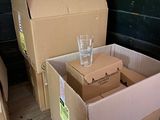 two boxes and a glass on the floor next to each other