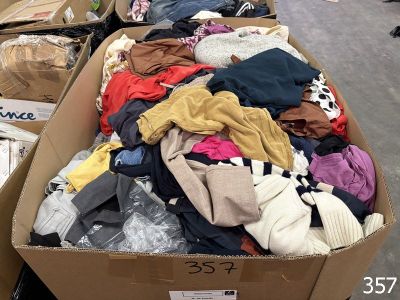 a large box full of clothes on the floor