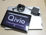 a tablet computer sitting on top of a table next to a charger