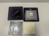 a box with a pen, a notepad, and a pen in it