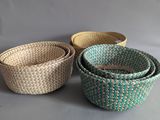 three woven baskets sitting on top of a table next to each other