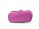 a small pink bag sitting on top of a white surface