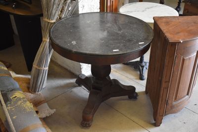 a small table with a marble top in a room