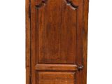 an old wooden cabinet with a door on top of it