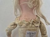 a doll that has a tag on it ' s neck