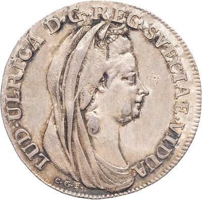 a close up of a silver coin with a woman ' s head