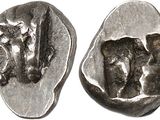 a close up of a silver coin with a face on it