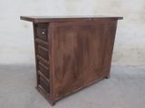 a small wooden cabinet with drawers on top of it