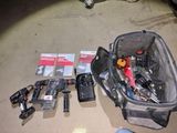 the contents of a tool bag are laid out on the floor