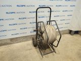 an image of a cart with a hose on it in front of a wall