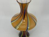a glass vase sitting on a table with a white background