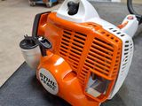 an orange and white blower sitting on top of a black table