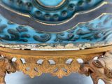 a blue and gold vase sitting on top of a table