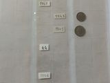 a lot of coins on the table with labels on them