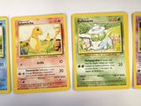 several pokemon cards are hanging on a wall in a room