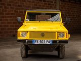 a yellow truck parked in a garage next to a brick wall