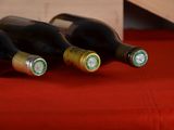 three bottles of wine sitting on a red table