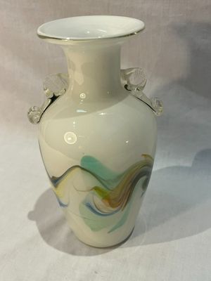a white vase that is sitting on a table