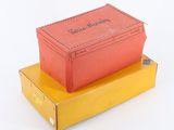 two boxes stacked on top of each other on a white surface