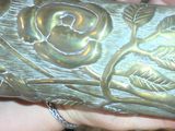 a person holding a metal object with a bird on it
