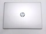 a white laptop with a hp logo on the screen