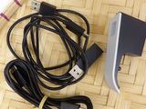 a picture of a cell phone and a charger on a table