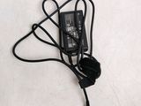 a black cord connected to a charger on a white surface