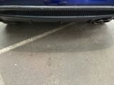 a picture of a blue car parked in a parking lot