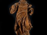 an old wooden statue of a woman holding a shield and shield