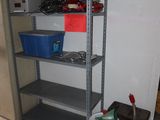 a metal shelving with a lot of items on top of it
