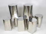 several pieces of silver metal on a white surface