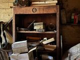 a room with a book shelf and a chair in it