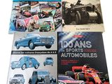 three books of cars and vintage cars on display on a white surface