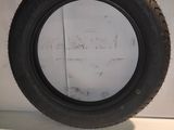 a close up of a tire on a white surface with a white wall in the background