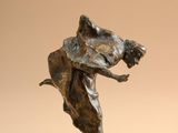 bronze sculpture of a woman holding a dog on a wooden base