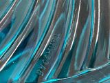 a close up of a glass bowl with a spoon inside of it