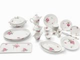 a white table setting with pink roses on it