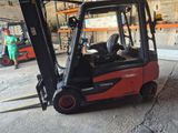 a red fork truck that is parked in a warehouse