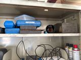 a metal shelf with a bunch of tools on it
